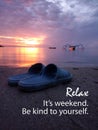 Weekend inspirational words - Relax. It`s weekend. Be kind to yourself. With a pair of blue sandals and sunrise background. Royalty Free Stock Photo