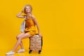 Weekend Journey Concept. Dreamy Girl Sitting On Suitcase And Looking Away Royalty Free Stock Photo