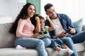 Weekend Leisure. Arab Family Of Three Playing Video Games In Living Room Royalty Free Stock Photo