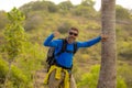 Weekend outdoors - young happy and attractive hiker man with backpack walking around in the wood enjoying hiking activity and Royalty Free Stock Photo