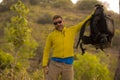 Weekend outdoors - young happy and attractive hiker man with backpack walking around in the wood enjoying hiking activity and Royalty Free Stock Photo