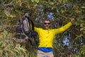 Weekend outdoors - young happy and attractive hiker man with backpack walking around in the wood enjoying hiking activity and Royalty Free Stock Photo