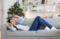 Weekend Passtime. Cheerful Asian Lady Enjoying Listening Music At Home, Wearing Headphones