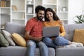 Weekend Passtime. Happy Indian Couple Using Laptop Computer At Home Together