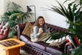 Weekend Pastime. Young Woman smile Relaxing In Armchair With Book And Coffee Enjoying Spending Time At Home home trees around.