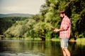 weekend relax. mature bearded man with fish on rod. hipster fishing with spoon-bait. fly fish hobby. Summer fishery Royalty Free Stock Photo