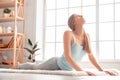 Weekend. Woman exercise at home on carpet stretching back peaceful