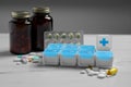 Weekly pill box with medicaments on white marble table Royalty Free Stock Photo