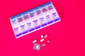 Weekly Pill Box Container On Smooth Red Background Royalty Free Stock Photo