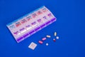 Weekly Pills In Pill Box On Smooth Blue Background