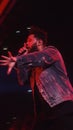 The Weeknd performing live at a concert in Oakland California