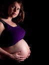 36 weeks pregnant young woman holding her naked belly