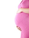 36 weeks pregnant young woman in pink holding her belly