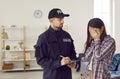 Weeping woman talking to police officer after breaking into house Royalty Free Stock Photo