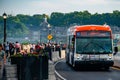 WeGo Transit NovaBus LFX Articulated Bus passes some tourists in Niagara Falls Royalty Free Stock Photo