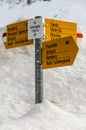 Trail sign with various hiking destinations on the Schwaegalp in snow