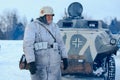 Wehrmacht officier in winter camouflage with the Sd.Kfz. 251 Sonderkraftfahrzeug 251. Royalty Free Stock Photo