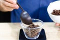 Weighing coffee grains on digital scale. Hands of male barista pouring roasted coffee grains on a scale before brewing Royalty Free Stock Photo