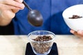 Weighing coffee grains on digital scale. Hands of male barista pouring roasted coffee grains on a scale before brewing Royalty Free Stock Photo