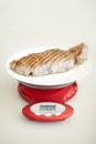 Weighing dinner, scale and measuring beef for calories, nutritional value and protein on a plate. Healthy meat