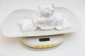 Weighing dirty used baby diapers on a scale. Determination of urine weight in one day. Medical research.