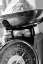 Weighing flour with home baking scales. Royalty Free Stock Photo