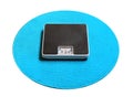 Weighing machine on a blue carpet. Royalty Free Stock Photo