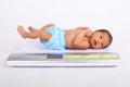 Weighing newborn baby boy on scale