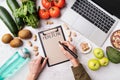 Female hands writing in the notepad words meal plan top view flat lay Royalty Free Stock Photo