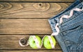 Weight loss concept, Blue jeans, green apples and measuring tape Royalty Free Stock Photo