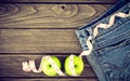 Weight loss concept, Blue jeans, green apples and measuring tape Royalty Free Stock Photo