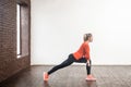 Weight loss concept. Profile woman doing gymnastics indoor. Royalty Free Stock Photo