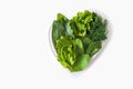 Weight loss diet. Fresh green leaf lettuce, spinach, sorrel, dill  on heart shaped plate on white background. Healthy eating. Royalty Free Stock Photo