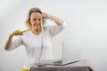 Weight loss fail concept. Scale and depressed, frustrated and sad woman sitting on floor holding head and arms on knees. Royalty Free Stock Photo