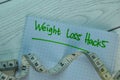 Weight Loss Hacks write on a book isolated on office desk