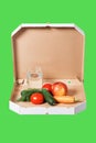 Weight loss and healthy eating or dieting concept. Open pizza box with raw vegetables and glass of water in it