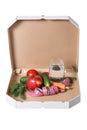 Weight loss and healthy eating or dieting concept. Open pizza box with raw vegetables, water and measuring tape in it