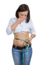 Weight Loss and Healthy Lifestyle Concept. Fitness Woman Measuring Her Waistline with Measure Tape Royalty Free Stock Photo