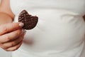 Fat woman snacking with chocolate cookie. Diet