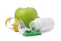 Weight loss pills, bottle, apple and measuring tape Royalty Free Stock Photo