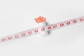 Weight loss pills and bottle with measuring tape on white background Royalty Free Stock Photo