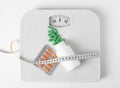 Weight loss pills, bottle, scales and measuring tape on white background Royalty Free Stock Photo