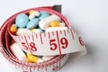 Weight loss pills and measuring tape Royalty Free Stock Photo