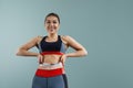 Weight loss, slim body, healthy lifestyle concept. Fit fitness girl measuring her waistline with measure tape. Royalty Free Stock Photo