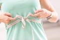 Weight loss and slim body of a young woman. Girl measuring her waistline body with measure tape Royalty Free Stock Photo