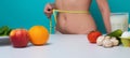 Weight loss. Woman measure waistline with weight loss.. Calories and fruit diet concept. Vegetarian fresh food for Royalty Free Stock Photo