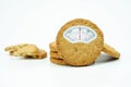 Weight scale composite on grain cookies on white background