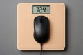 Weight scale showing 72.4 while a computer mouse rests on it, depicting unusual object placement Royalty Free Stock Photo