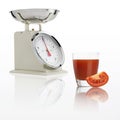 Weight scale with tomato juice glass isolated on white background Royalty Free Stock Photo