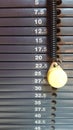 Weight stack gray scale with graduation in kilograms with yellow pin